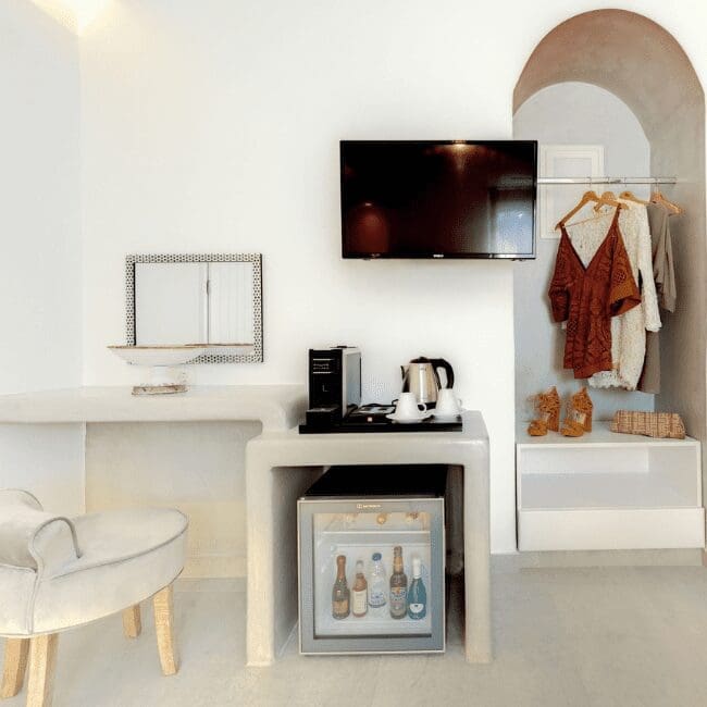 One Bedroom Suite with a TV, minibar, vanity and arched open wardrobe