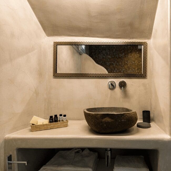 One Bedroom Suite bathroom with a stone basin and rectangular mirror