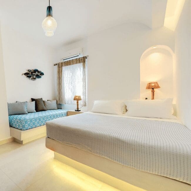 One Bedroom Suite with a double bed, built-in sofa and arched bedside niche
