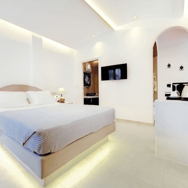 Standard Suite with a double bed, wall-mounted TV and open-plan dressing area