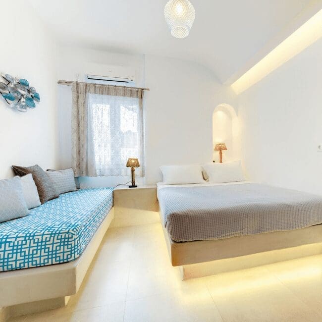 One Bedroom Suite bedroom with a double bed and blue Cycladic seating