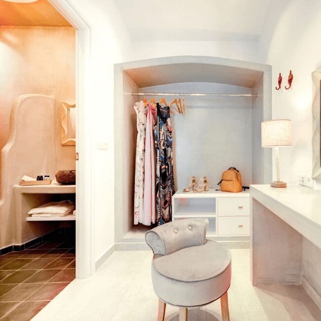 Dressing area with an open wardrobe and vanity in the Suite with Pool View
