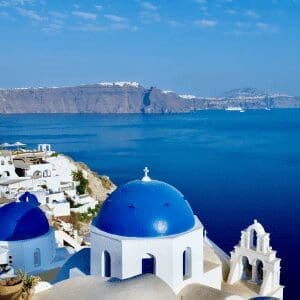 Blue-domed white churches overlooking the Santorini caldera