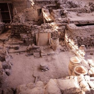 Ancient clay storage jars among the excavated ruins of the Akrotiri archaeological site, Santorini