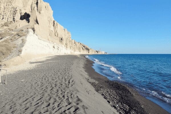 Vlychada beach with wind-sculpted white cliffs and dark volcanic sand, Santorini